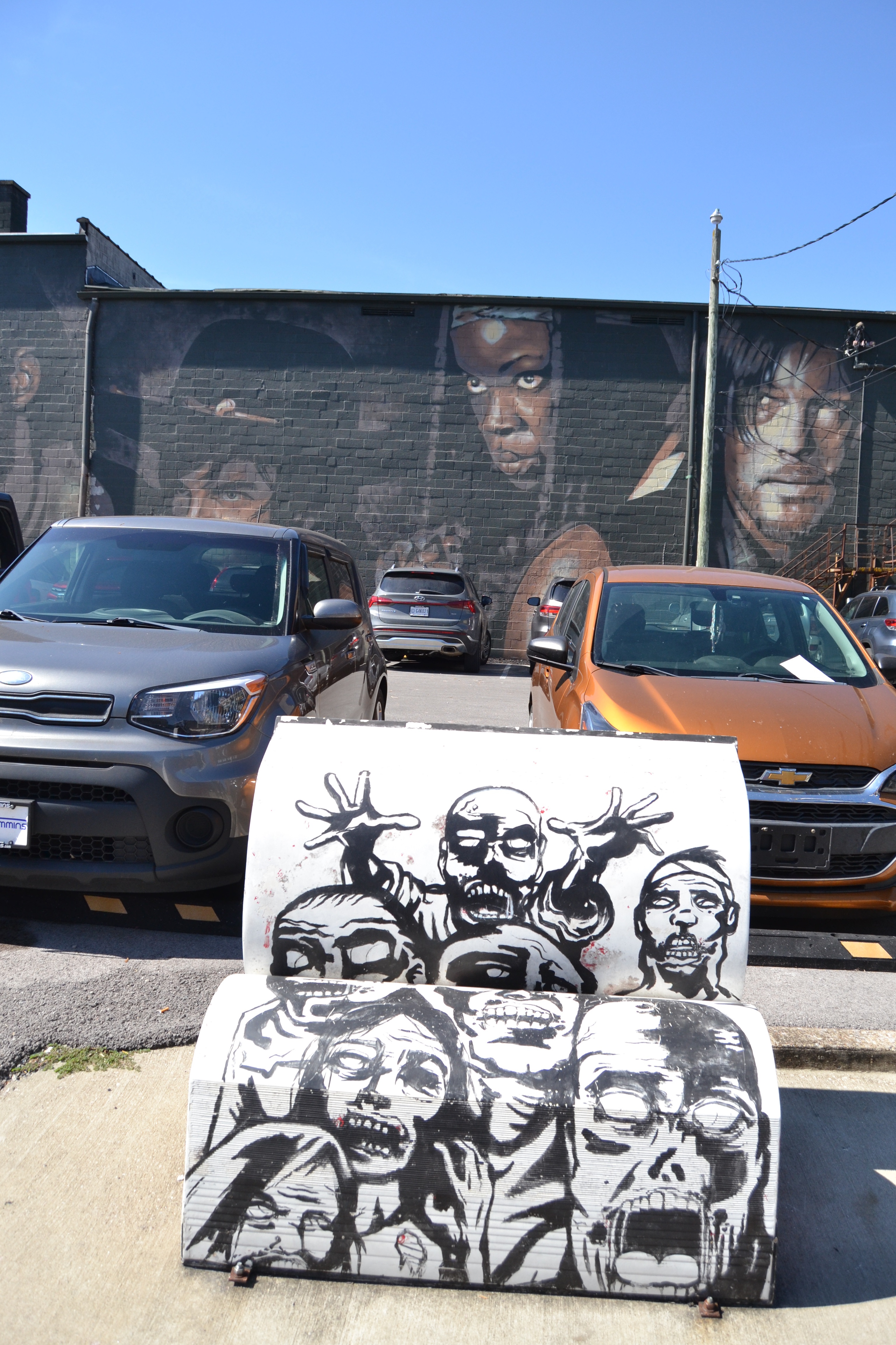 Walking Dead bench in front of a mural of Walking Dead characters